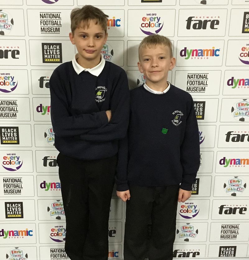 Two Y5 boys photographed against the project bannerstand