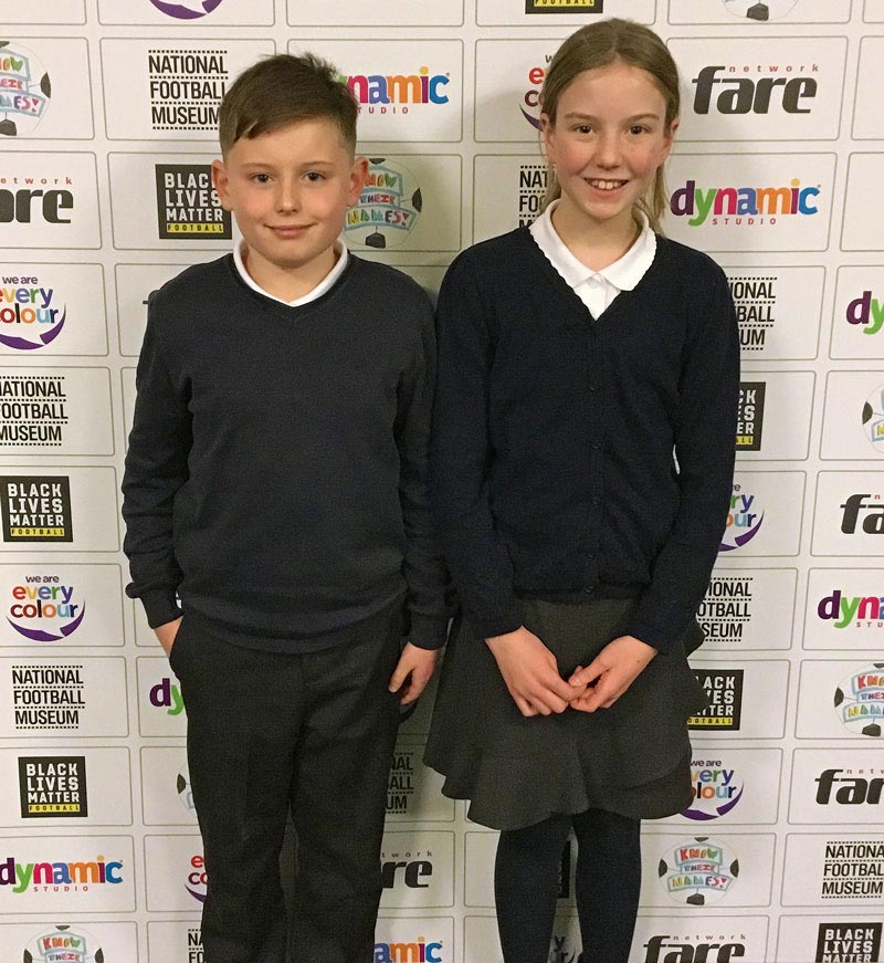 Two Y5 pupils photographed against the project bannerstand